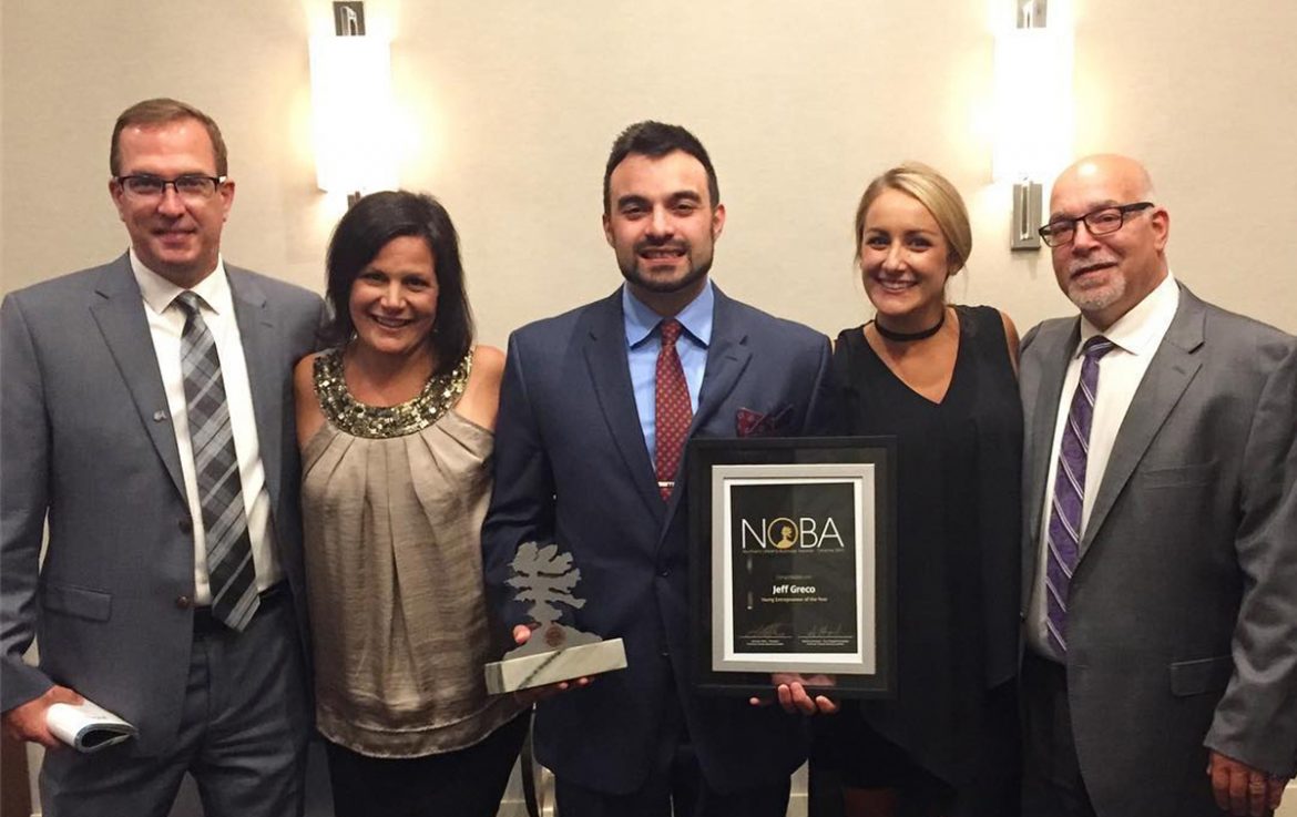 Jeff Greco, alongside friends, holding his NOBA.